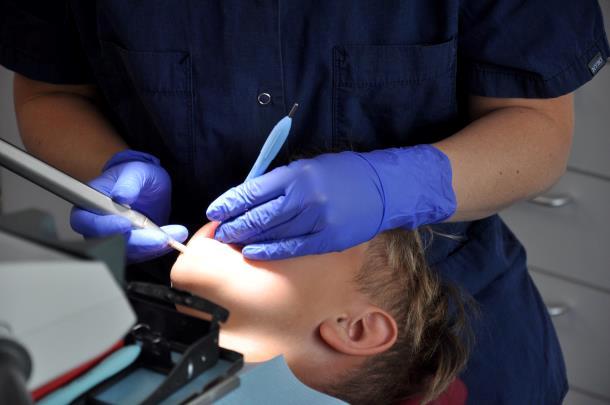 Tandplejeren viser eleven røngtenbilleder af hans tænder